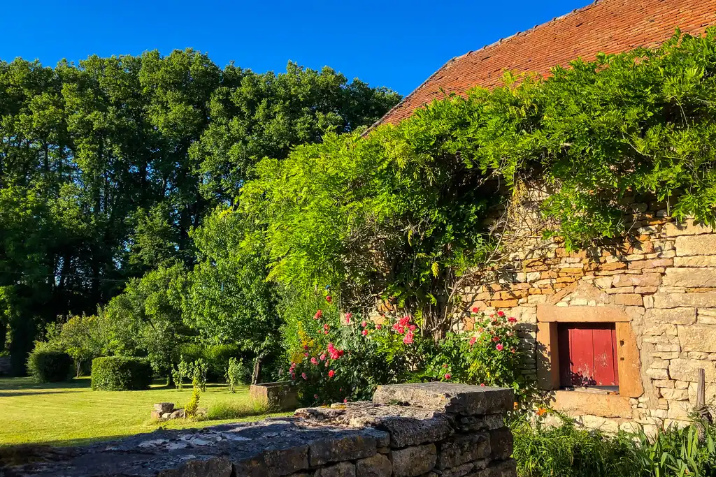 Ein schönes Steinhaus im Burgund mit einem großeb Garten und Blumen