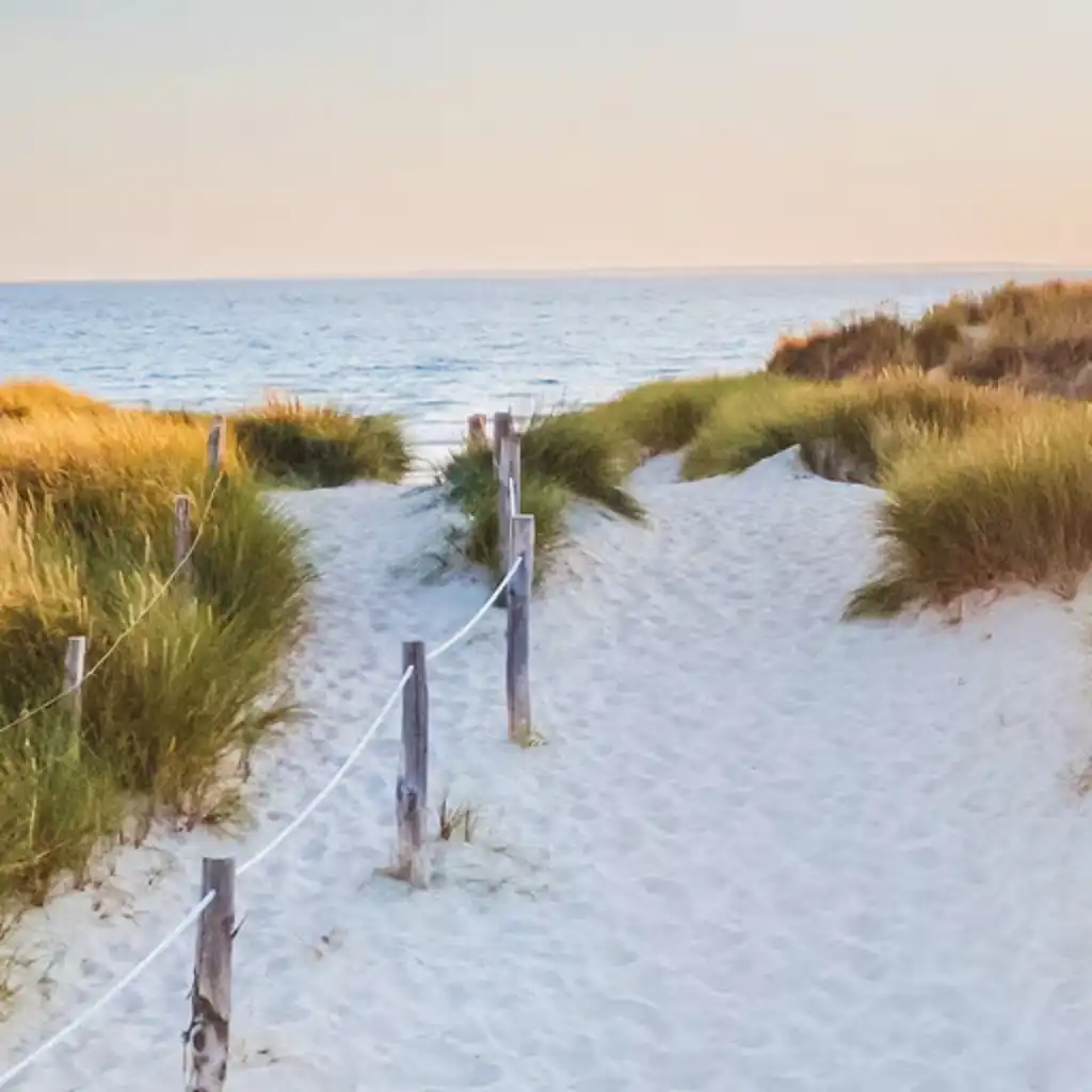 Weiße Sanddünen mit Meer im Hintergrund
